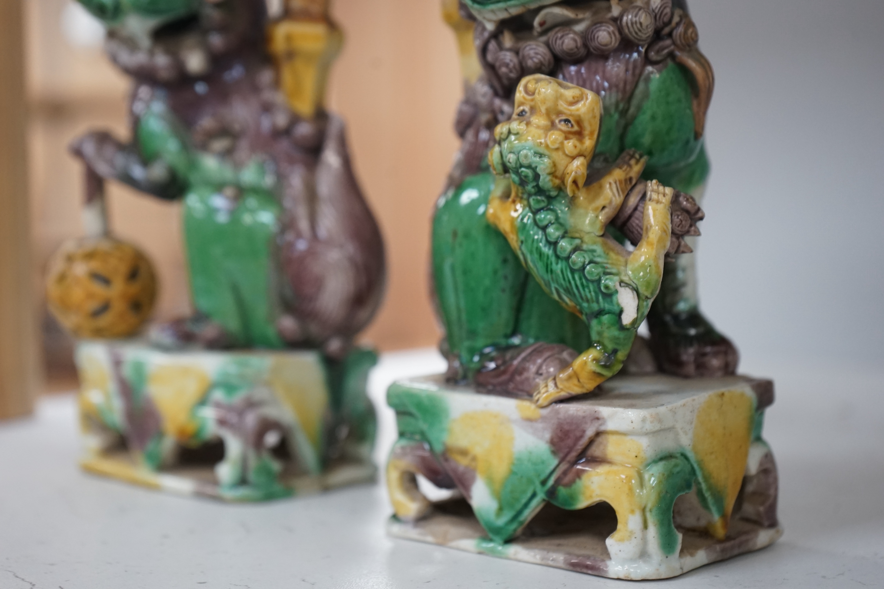 A pair of Chinese Sancai glazed lion joss stick holders, 18th century, 17cm high. Condition - some restoration